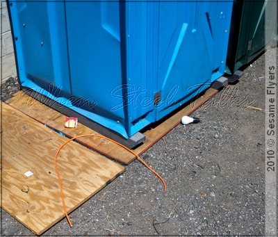 Cut extension cord on ground next to portable toilets