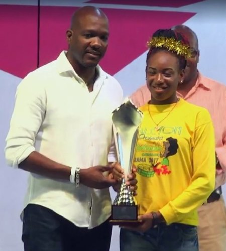 ACB board member Daryll Matthew presents Halcyon Steel Orchestra player with second-place trophy
