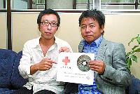 Japanese Katsunari Imai, left, and Yoichi Watanabe display their CD, titled What The World Needs Now Is Love