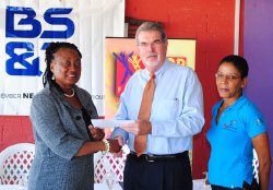 Dr. Donna Hunte-Cox receives the sponsorship cheque from BS&T Chief Executive Officer Mr. Anthony King, looking on is Ms. Karen Pestaina, Coordinator of Pan Pun De Sand