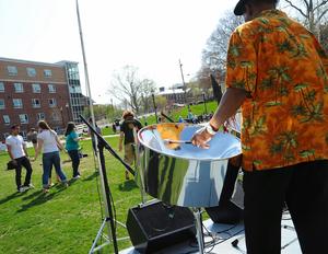 A member of the Tropical Beat Steel Band plays a steel drum as Bridgewater State University students dance to the rhythm