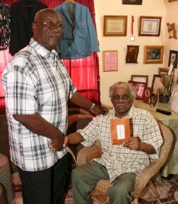 Anthony Williams (seated) with plaque presented by NCC chairman Patrick Arnold