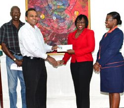 Handing over of the sponsorship cheque for the Mash Steel Pan Competition to the Minister of Culture, Youth and Sport Dr. Frank Anthony by Manager of Marketing and Communication, Michelle Johnson. To the Ministers right is Mash Secretariat Coordinator Lennox Canterbury and to Johnsons left is the Banks PR officer, Jonelle Dummett 