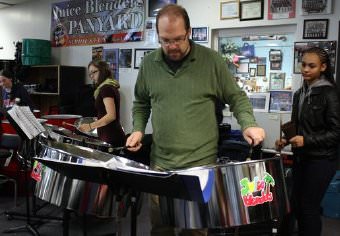 Joel Smales, director of the Juice Blenders Steel Drum Band at Binghamton High School often chooses not to conduct, but join in with the band.