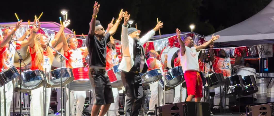Pan Evolution Steel Orchestra on stage with arranger André White (center) and artists “Full Blown” for New York Panorama 2026