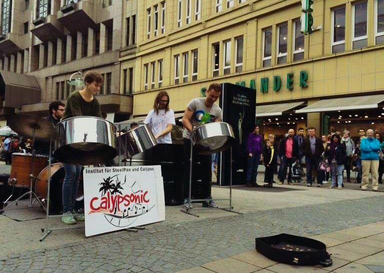 Justina Ploeger (at left) busking with Calypsonic e.V. - Institute 
			for Steel Pan and Calypso